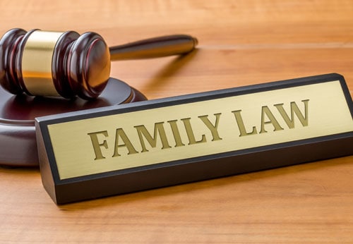 A legal symbol representing family law, displayed on a rustic wooden table.